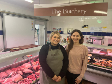 Photo of Aphra in front of the Butchery at Rose Farm Shop
